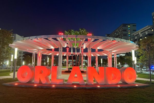 lit sign reading 'Orlando' in front of circular pergola