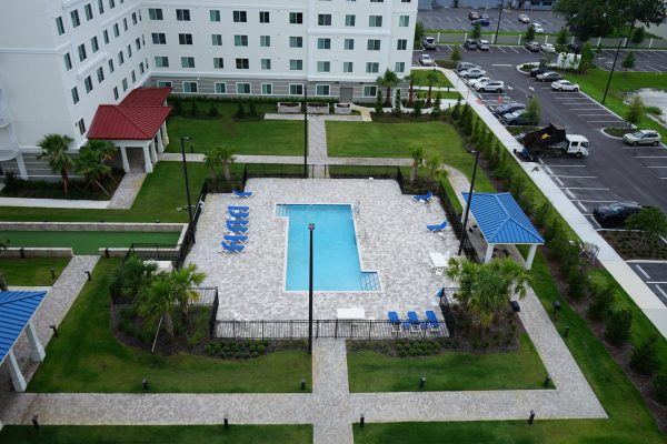 aerial view of pool between two tall apartment buildings
