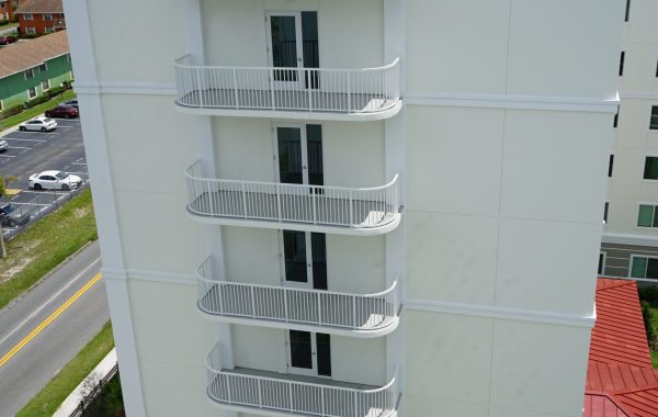 tall white building with metal balconies