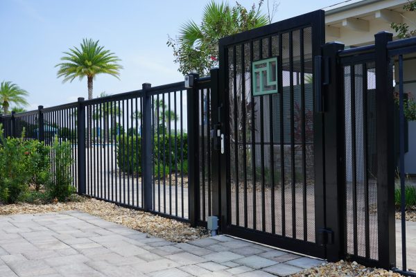 black fence and gate in front of building